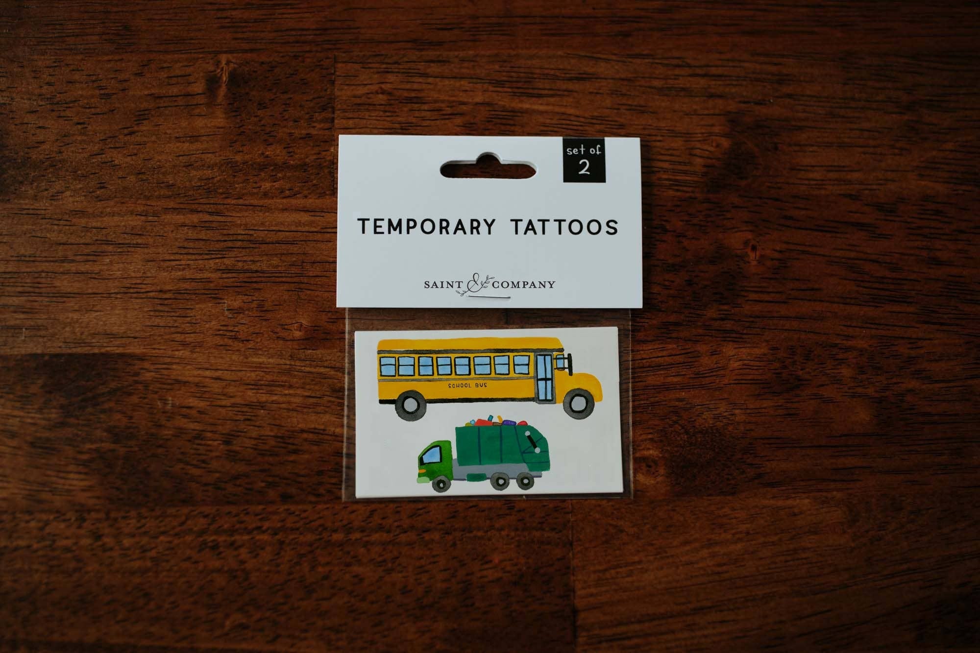 School bus + trash truck
Set of 2 temporary tattoos
Size of sheet: 3 inch x 2 inch
Application Directions: Place the tattoo face down on skin. Apply even pressure to the tattoo paper backing using a wet cloth. Wait a minimum of 60 seconds and then remo
