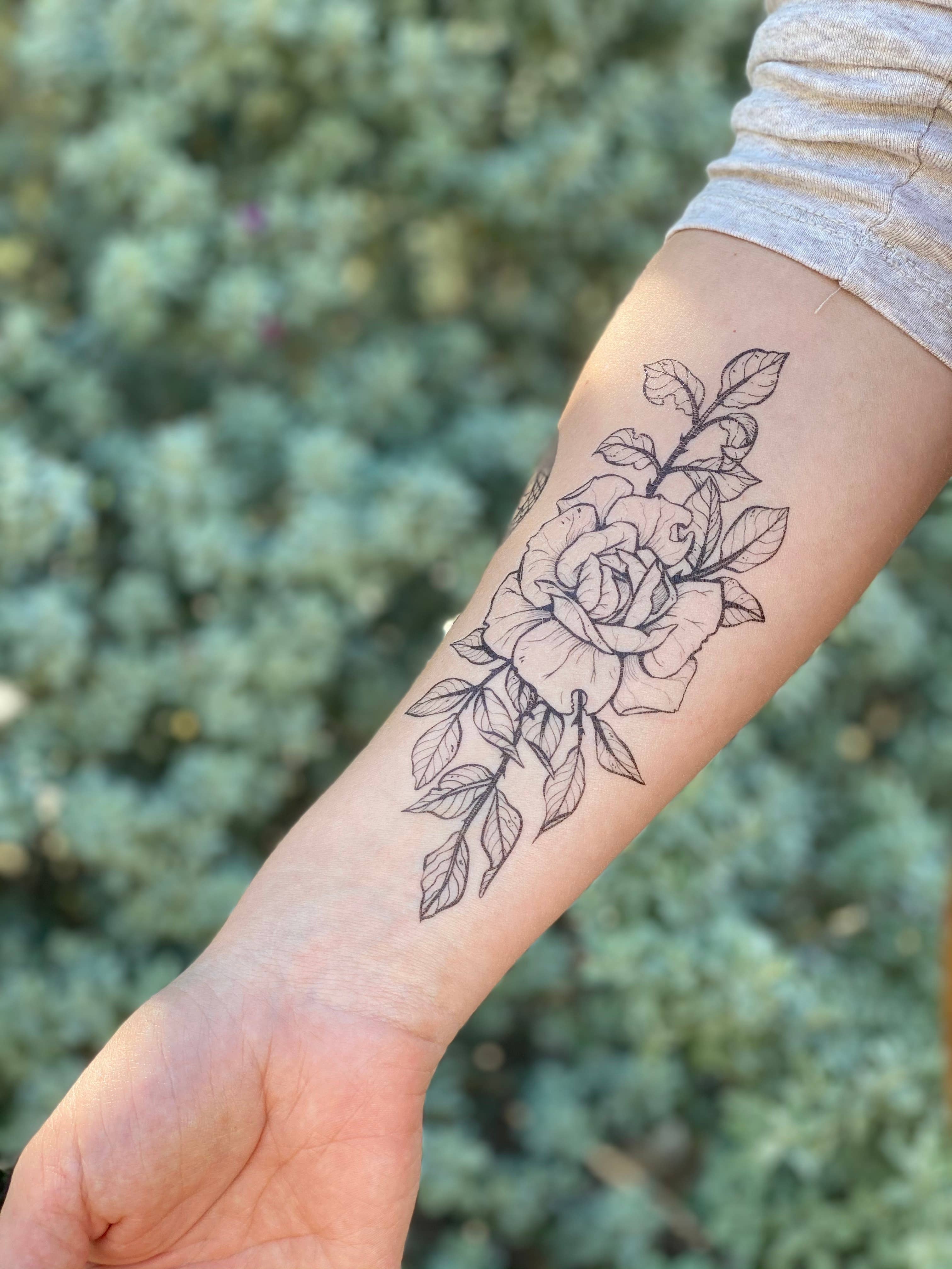 Rose Blossom temporary tattoo 2 pack. A rose with round petals, freshly clipped from the garden with several leaves and stems attached. She's 6" long
All tats now come in 2 Packs!
Lasts 2-5 days • Water-resistant • Comfortable • Skin Safe
All original de