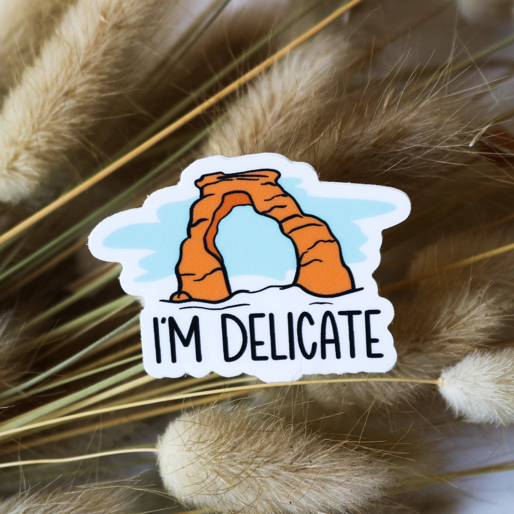 Delicate Arch is one of the most iconic arches in Arches National Park. This sticker was inspired by that iconic arch and its name.
Size: 2" x 1.5"
All of our stickers are made using waterproof, weatherproof, and dishwasher-safe vinyl with a matte laminat