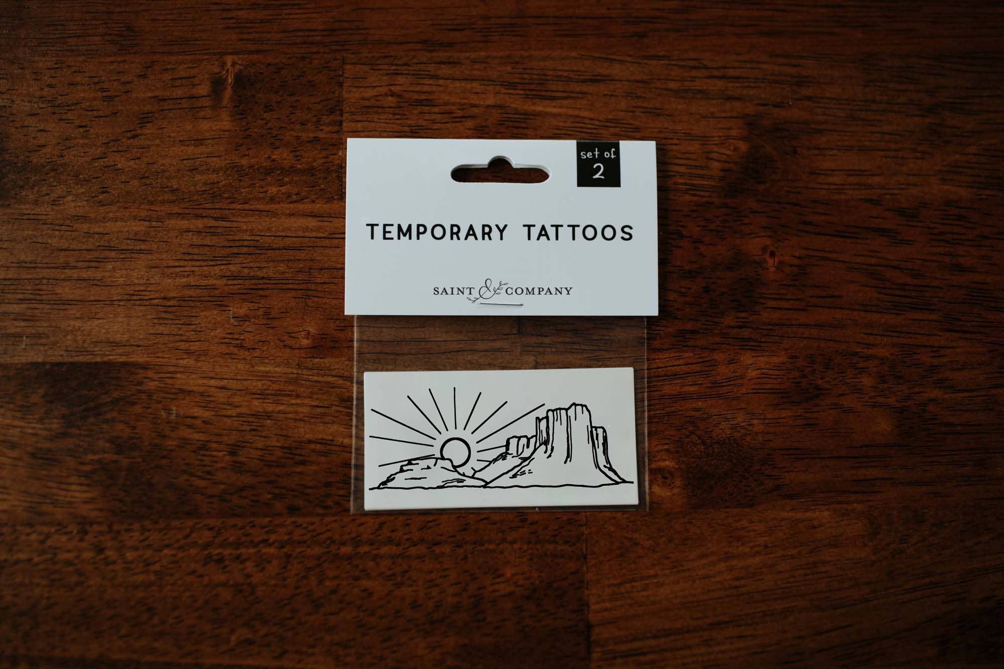 Featuring a thoughtfully hand drawn desert scene, this set of temporary tattoos makes a thoughtful small gift to any desert dreamer, or a pain-free way to try out a tattoo!

DETAILS:
Set of two temporary tattoos
Dimensions: 3" x 1.5"
Safe, non-toxic, and 