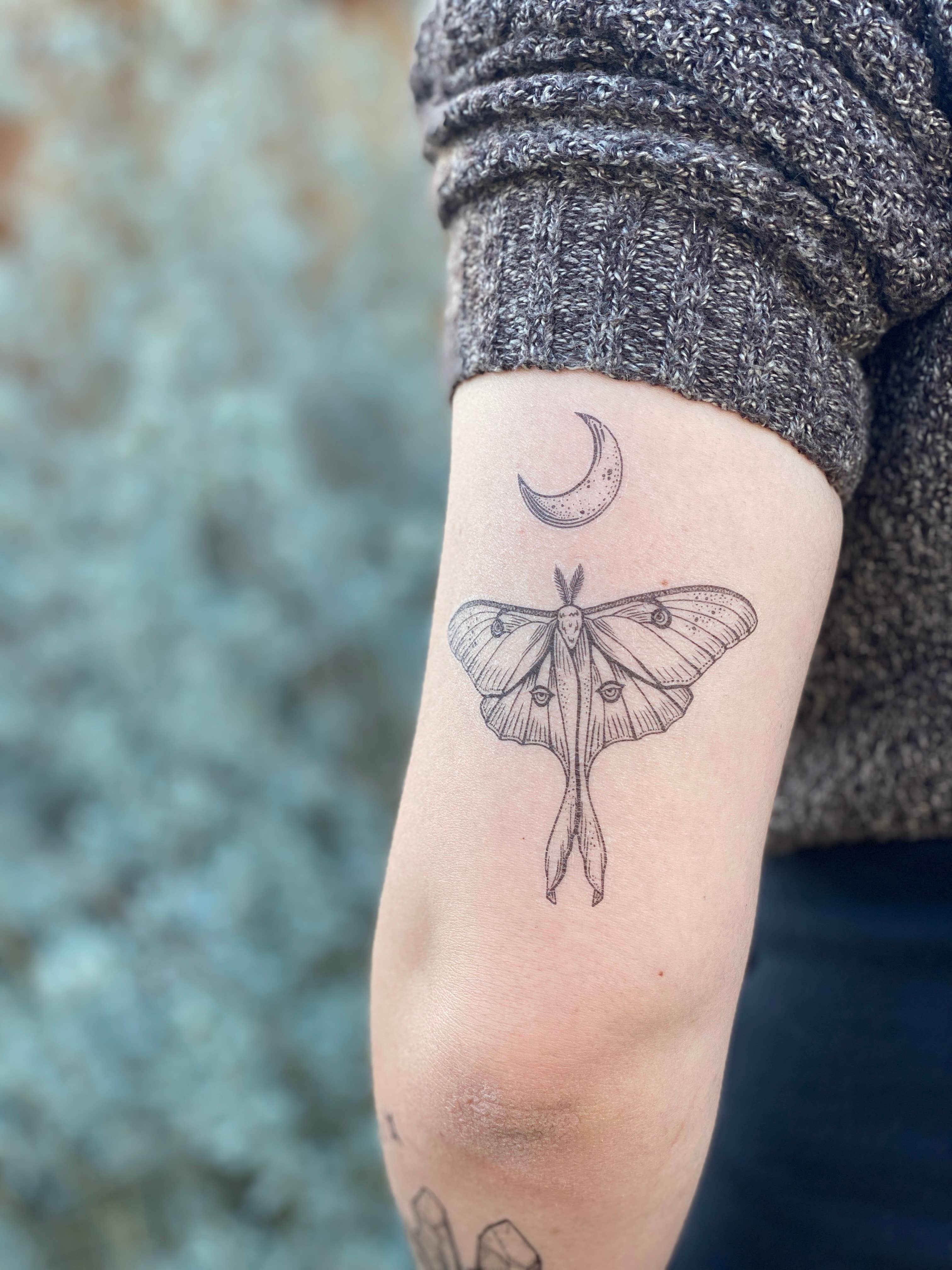 Luna Moth temporary tattoo 2 pack. Luna moths are a pale green moth, with small eye-shaped patterns on each wing. Their wings each have an elongated double ribbon-like tail, which is one of their most recognizable features. This original hand-drawn design