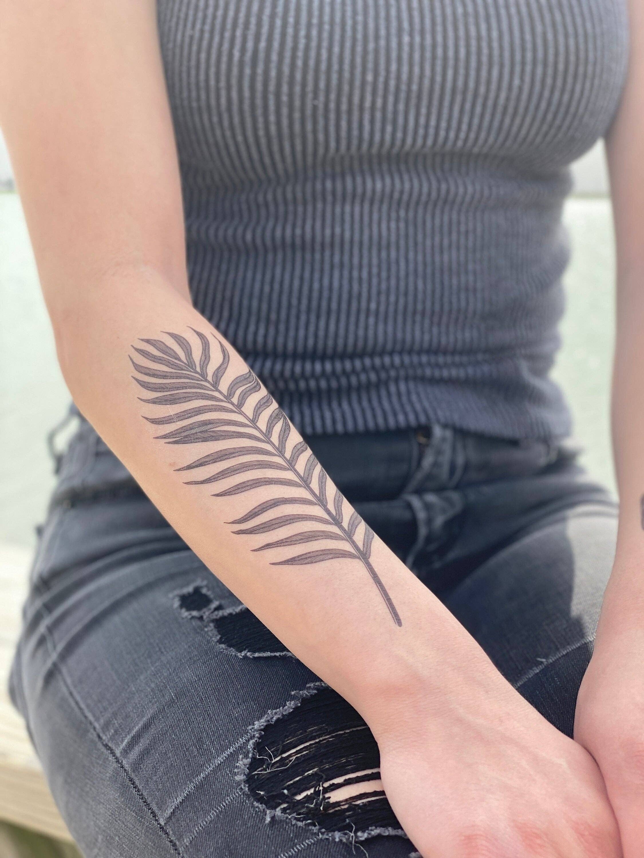 Palm Leaf temporary tattoo 2 pack. Designed with naturally flowing dark leaves with fine lines. This tat pairs perfectly with our Tropical Floral tat.

The length of this tat is 6.75 inches and the width is 2.75 inches.

All tats now come in 2 Packs!
Last