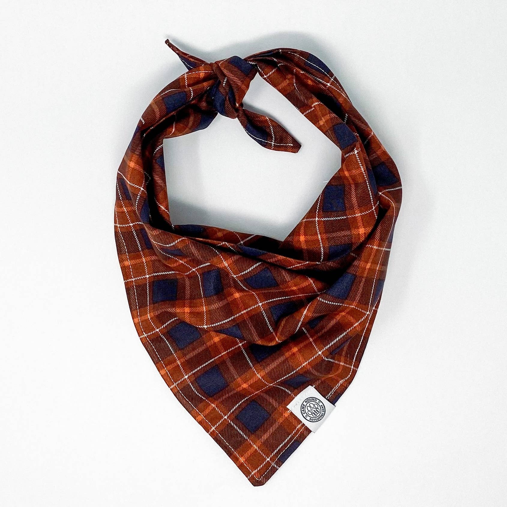 Add some cozy warmth to your wardrobe with the Evermore Bandana. This navy and orange plaid bandana is the perfect accessory to stay stylish this fall! Perfect for trips to the pumpkin patch or apple orchard.

All of our bandanas are tie-on.
We recommend 
