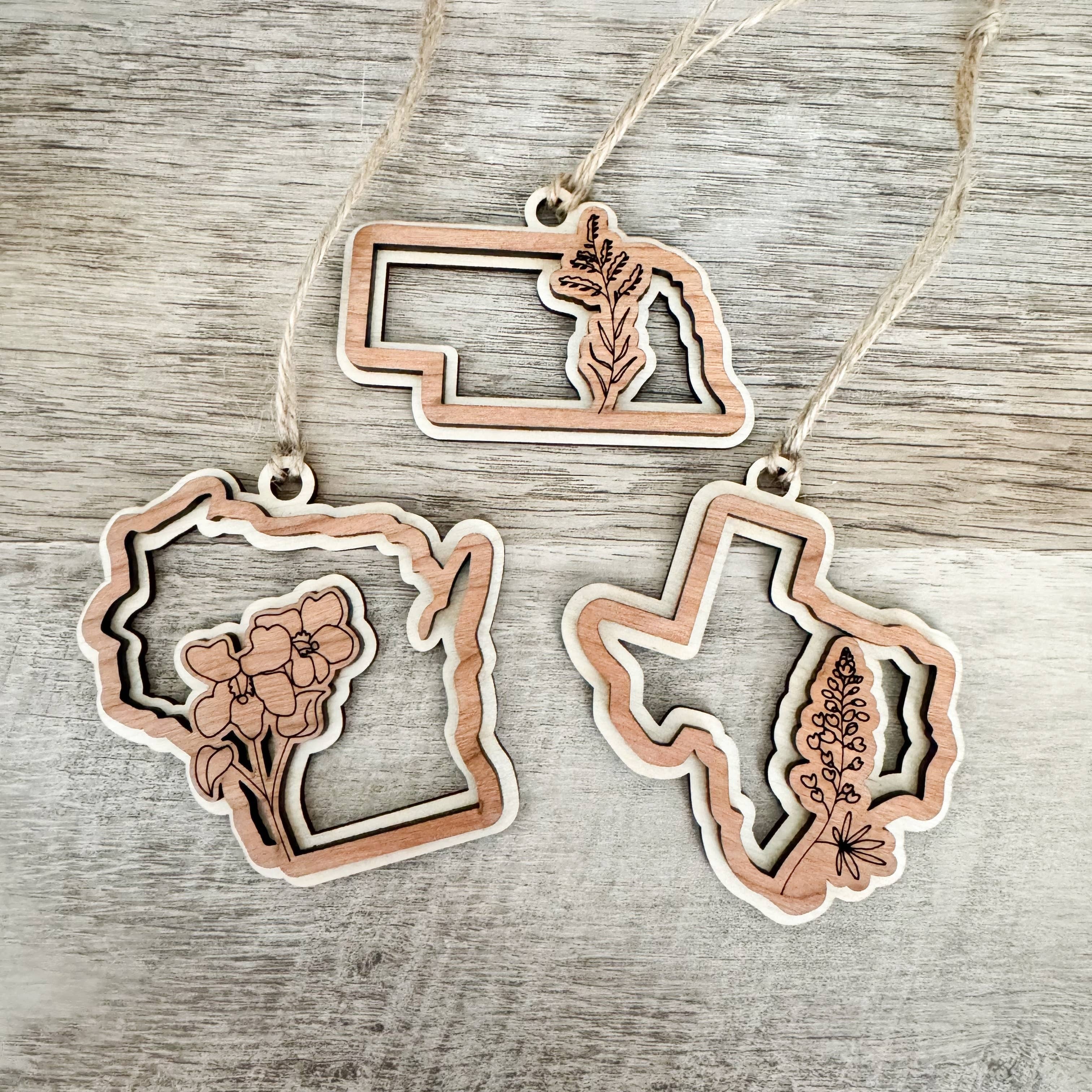 Gorgeous wooden state flower Christmas ornaments are the perfect addition to your shop this holiday season.

*All 50 States Available*

FINISHED- Every ornament is handcrafted with 2 layers of beautiful birch wood + cherry wood and finished with a silky-s